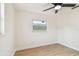 Bright bedroom with wood-look floors, ceiling fan, and a large window for natural light at 3818 Grove S St, St Petersburg, FL 33705