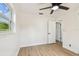 Bedroom featuring wood-look floors, a window, and a door to an adjoining room at 3818 Grove S St, St Petersburg, FL 33705