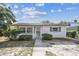 Charming single-story home featuring a well-maintained lawn, tidy landscaping, and neutral-tone exterior paint at 3818 Grove S St, St Petersburg, FL 33705