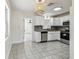 Bright kitchen with stainless steel appliances, granite counters, and a woven light fixture at 3818 Grove S St, St Petersburg, FL 33705