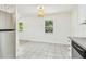 Eat-in kitchen showcasing tile flooring, stainless steel appliances, and great natural light from multiple windows at 3818 Grove S St, St Petersburg, FL 33705