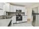 Bright kitchen with white cabinets, stainless steel appliances, and durable countertops at 3818 Grove S St, St Petersburg, FL 33705