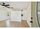 Bright living room with new light wood flooring, a stylish divider wall, and view to the eat-in kitchen at 3818 Grove S St, St Petersburg, FL 33705