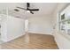 Bright living room showcasing wood-look flooring, white brick feature, and open access to other rooms at 3818 Grove S St, St Petersburg, FL 33705