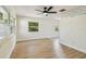 Open-concept living area with light wood flooring, plenty of natural light, and modern ceiling fan at 3818 Grove S St, St Petersburg, FL 33705
