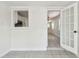 Bright sunroom featuring tile flooring, white wood paneling, and a convenient pass-through window to the adjacent kitchen at 3818 Grove S St, St Petersburg, FL 33705