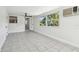 Bright sunroom featuring tile flooring and plenty of natural light, connecting to an open doorway at 3818 Grove S St, St Petersburg, FL 33705