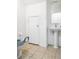 Simple bathroom with a pedestal sink, toilet, and tiled floor at 3866 Mariner Dr, St Petersburg, FL 33705
