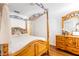 Well-lit bedroom with a four-poster bed, wood floors, and natural light at 3866 Mariner Dr, St Petersburg, FL 33705