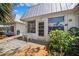 Backyard with patio area, white outdoor furniture, lush greenery and garden at 4229 Glissade Dr, New Port Richey, FL 34652