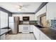 Functional kitchen with white cabinets, granite countertops, mosaic backsplash, and stainless steel appliances at 4229 Glissade Dr, New Port Richey, FL 34652