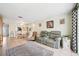 Comfortable living area with a reclining sofa, area rug, and views into the dining room at 4229 Glissade Dr, New Port Richey, FL 34652