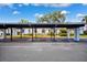 Exterior shot of covered parking area shows blue and white trim around arches at 4229 Glissade Dr, New Port Richey, FL 34652