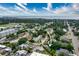 An aerial view of a neighborhood showcases lush greenery, serene waterfront views, and a charming residential street at 4411 W Bay Villa Ave, Tampa, FL 33611
