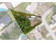 Aerial view of a property surrounded by lush greenery at 4411 W Bay Villa Ave, Tampa, FL 33611