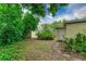 Backyard with a small building, lush greenery, and a charming stone pathway at 4411 W Bay Villa Ave, Tampa, FL 33611