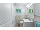 Bathroom features a light colored vanity, tile floors, and modern light fixtures at 4411 W Bay Villa Ave, Tampa, FL 33611