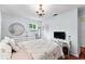 Light-filled bedroom features wood floors, chandelier, and light colored walls at 4411 W Bay Villa Ave, Tampa, FL 33611
