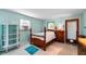 This bedroom has a full bed, a dresser, a cabinet, and plenty of natural light at 4411 W Bay Villa Ave, Tampa, FL 33611