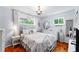 Charming bedroom with chandelier, wood floors, and natural light at 4411 W Bay Villa Ave, Tampa, FL 33611