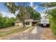 This inviting home has a carport, mature trees, a long driveway, and additional RV parking at 4411 W Bay Villa Ave, Tampa, FL 33611