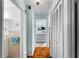 Hallway with wood floors leads to bathroom, kitchen, and bedroom area at 4411 W Bay Villa Ave, Tampa, FL 33611