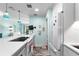 Bright eat-in kitchen with white appliances, marble floors, and unique light fixtures at 4411 W Bay Villa Ave, Tampa, FL 33611
