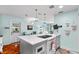 Bright kitchen features an island with white countertops and modern appliances and fixtures at 4411 W Bay Villa Ave, Tampa, FL 33611