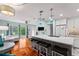 Bright, open kitchen features an island with bar seating connecting to a cozy living space at 4411 W Bay Villa Ave, Tampa, FL 33611