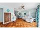 Stylish living room featuring hardwood floors, a modern ceiling fan, and plenty of natural light at 4411 W Bay Villa Ave, Tampa, FL 33611