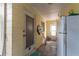 A covered patio featuring a back door, utility equipment, and a refrigerator at 4411 W Bay Villa Ave, Tampa, FL 33611