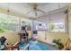 View of a screened-in porch filled with seating, a cat tree, a rug, and other decorations at 4411 W Bay Villa Ave, Tampa, FL 33611