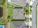 Aerial view of the home showcasing its landscaped yard, neighboring properties and proximity to a pond at 4496 Tatum Loop, Odessa, FL 33556