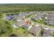 Aerial view of the home showcasing its pool, surrounding neighborhood, and proximity to a lake at 4496 Tatum Loop, Odessa, FL 33556