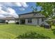 Spacious backyard with lush green grass, covered patio, and ample space for outdoor activities at 4496 Tatum Loop, Odessa, FL 33556