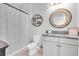 Charming bathroom with modern vanity, decorative mirror, and stylish shower curtain at 4496 Tatum Loop, Odessa, FL 33556