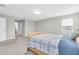 Bedroom with wicker bed, carpet flooring, and view to ensuite bathroom at 4496 Tatum Loop, Odessa, FL 33556