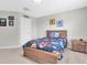 Comfortable bedroom with a wooden bed frame, soft bedding, and a bright, airy feel at 4496 Tatum Loop, Odessa, FL 33556
