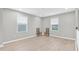 Bright upstairs bedroom with wood-look floors, windows, and modern decor at 4496 Tatum Loop, Odessa, FL 33556