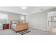 Bedroom with a wicker frame bed, side table, and neutral carpeting at 4496 Tatum Loop, Odessa, FL 33556