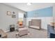 Calming Bedroom featuring a crib, comfortable chair, and soft decor, creating a peaceful atmosphere at 4496 Tatum Loop, Odessa, FL 33556