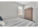 Bedroom with a patterned bedspread, wardrobe closet, and window at 4496 Tatum Loop, Odessa, FL 33556