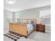 Bedroom featuring a wicker bed frame, bedside table, carpeting and ample natural light at 4496 Tatum Loop, Odessa, FL 33556