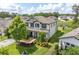 Stunning two-story home with manicured landscaping, mature trees, and charming front porch at 4496 Tatum Loop, Odessa, FL 33556