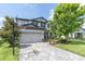 Traditional two-story home with a manicured lawn, and a spacious two-car garage at 4496 Tatum Loop, Odessa, FL 33556