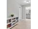 Hallway with view to a bathroom, featuring wood-look floors and a built-in bookshelf at 4496 Tatum Loop, Odessa, FL 33556