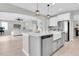 Open-concept kitchen features a large island, stainless steel appliances, and seamless flow to the living area at 4496 Tatum Loop, Odessa, FL 33556