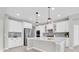 Bright kitchen features white cabinetry, an island, and stainless steel appliances, perfect for cooking at 4496 Tatum Loop, Odessa, FL 33556