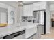 Modern kitchen with stainless steel appliances, a large island with sink, and ample cabinet space at 4496 Tatum Loop, Odessa, FL 33556