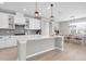 Stylish kitchen with white cabinetry, island seating, and adjacent dining area, ideal for Gathering gatherings at 4496 Tatum Loop, Odessa, FL 33556